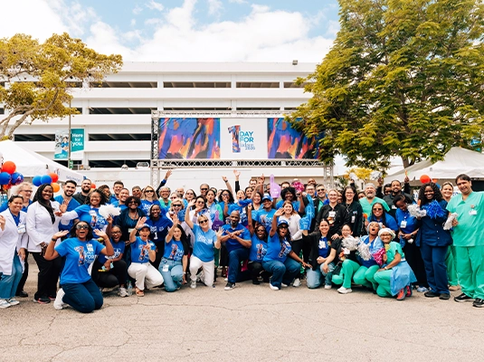 Photograph of a group of people in front of a Jackson Health building.