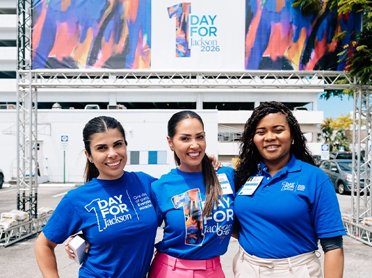 three women in blue t-shirts posing for the camera
