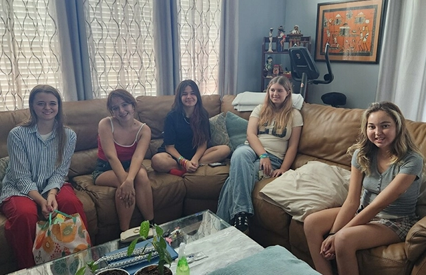 A group of women socializing in a living room.