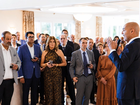 large group of people dressed in formal attire during an event