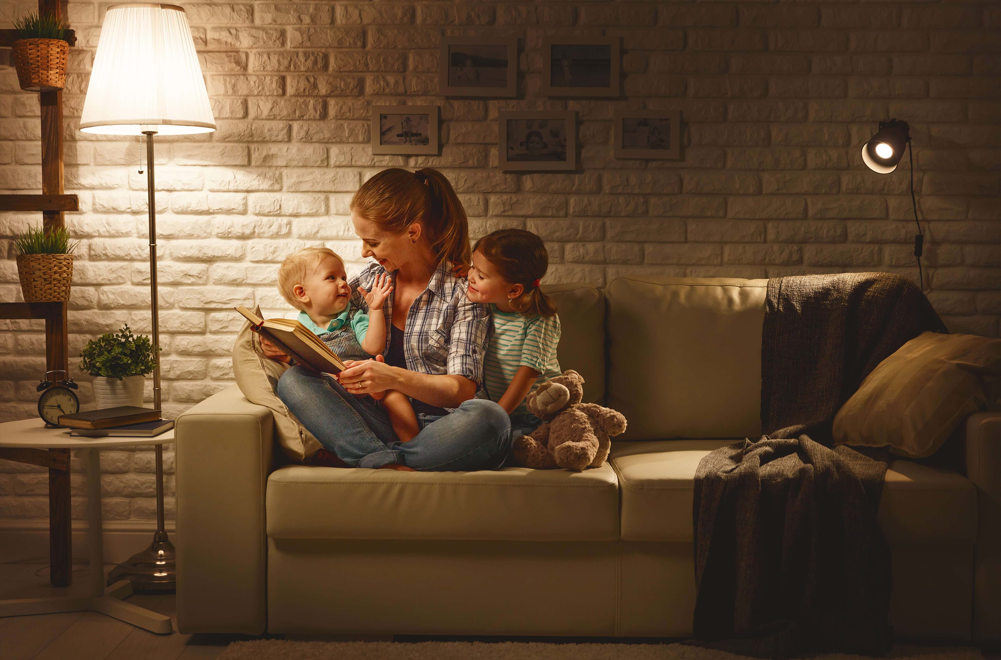 Mother reading to her children, using “task lighting”