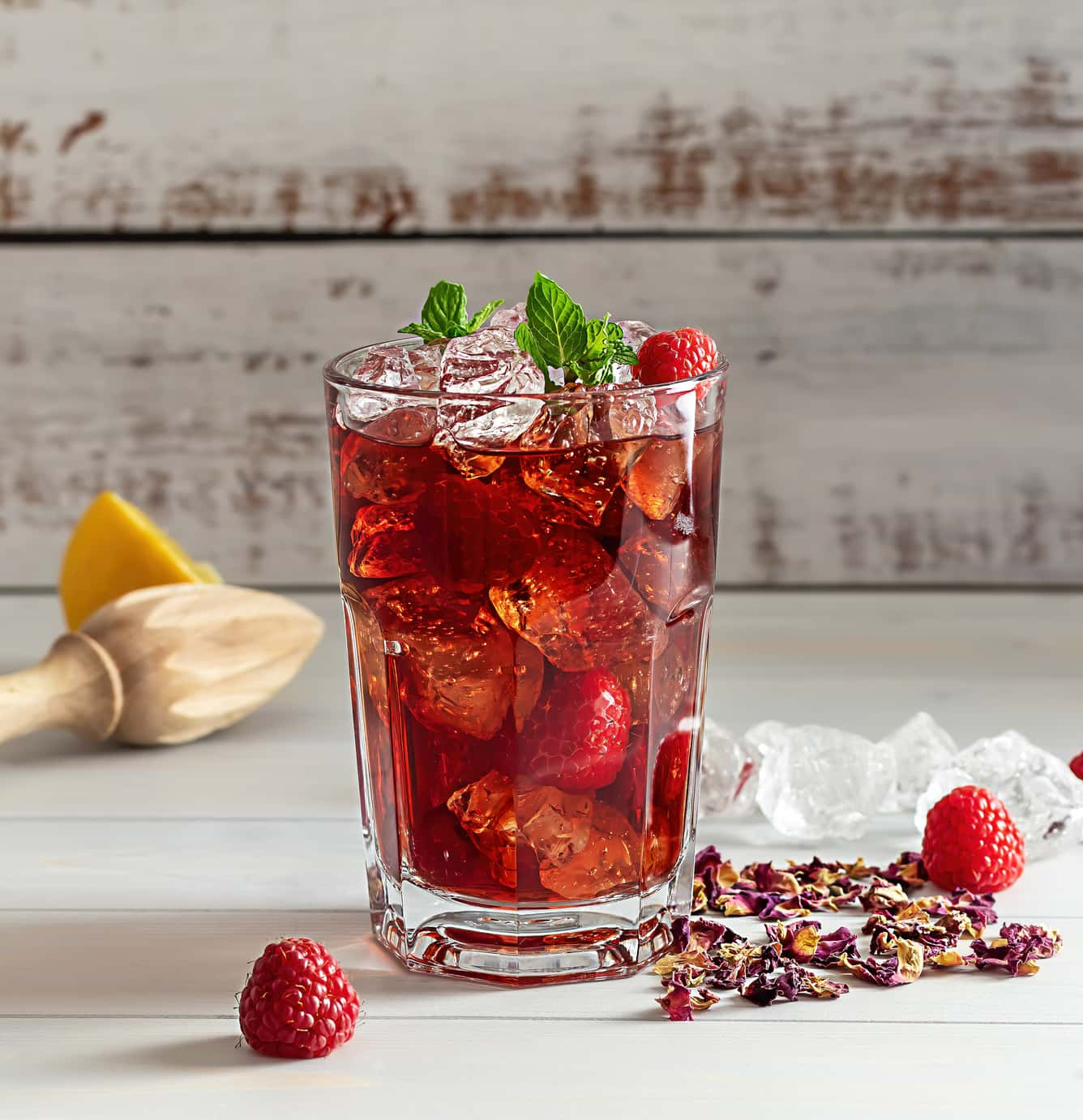 Glass of water aromatised with raspberries and mint.