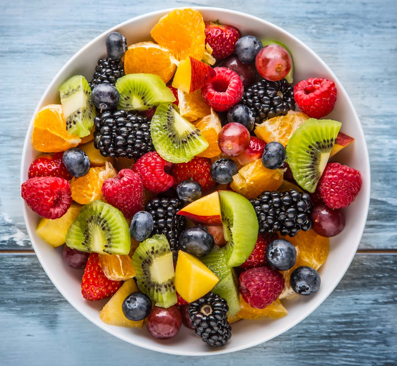 Fruit salad in a bowl on a wooden table.