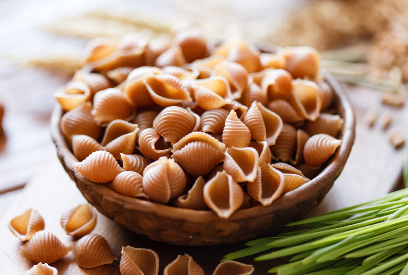 Wooden bowl of whole pasta.