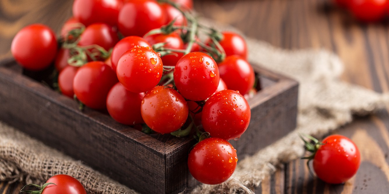 Wooden tray with cherry tomatoes.