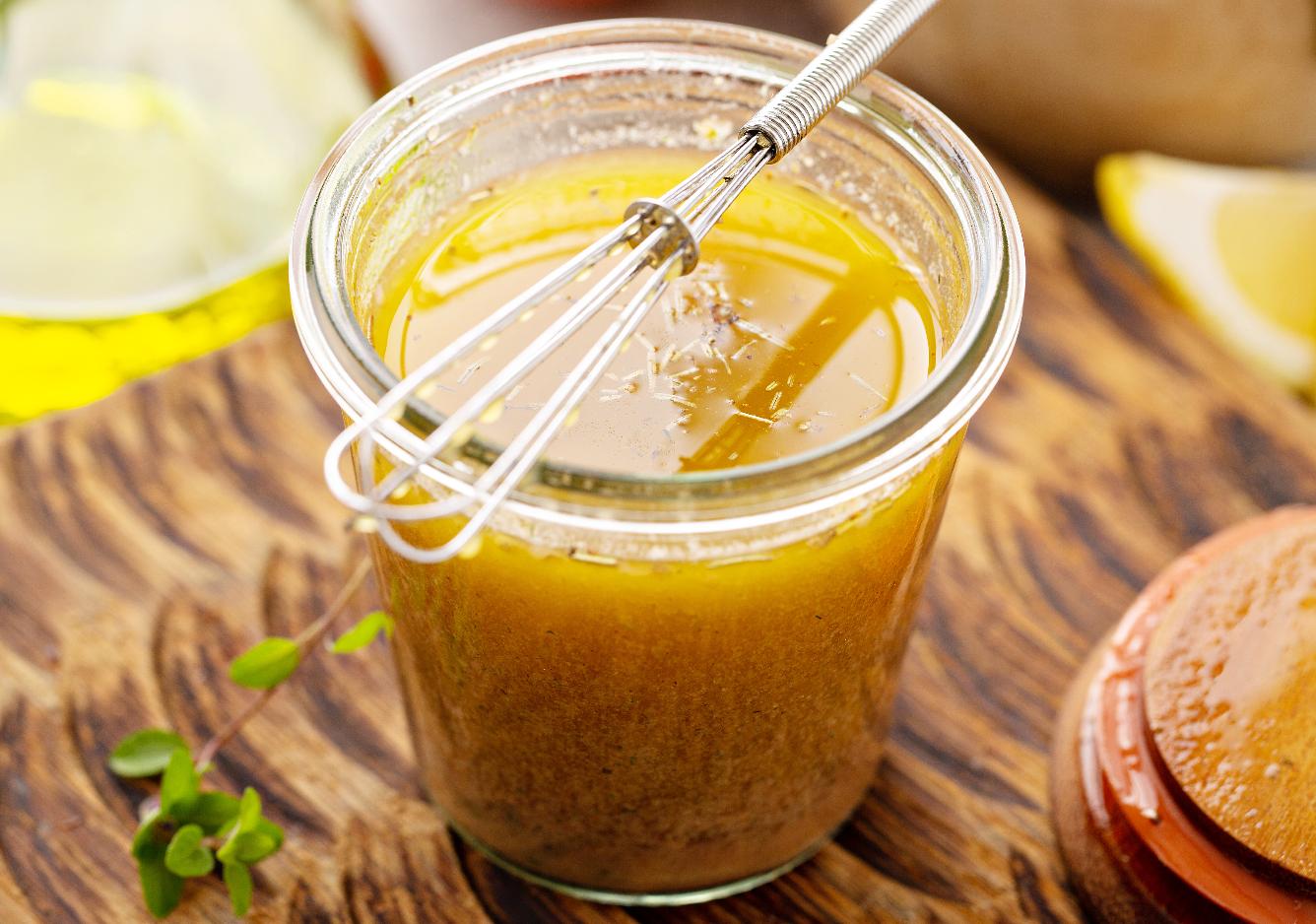 Jar of homemade sauce, with small egg beater.