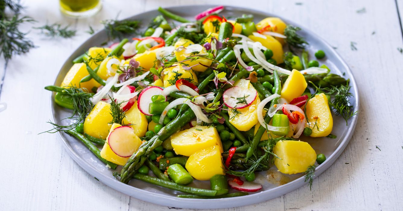 Ceramic plate with pea and mango salad.