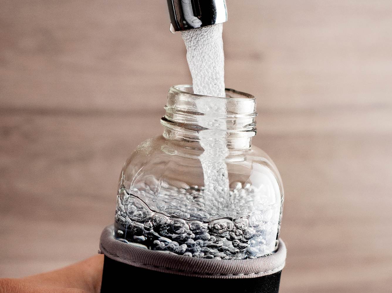 Reusable bottle being filled with water.