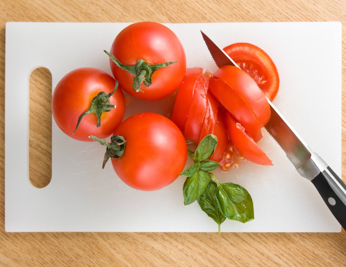 Plastic cutting board with tomatoes