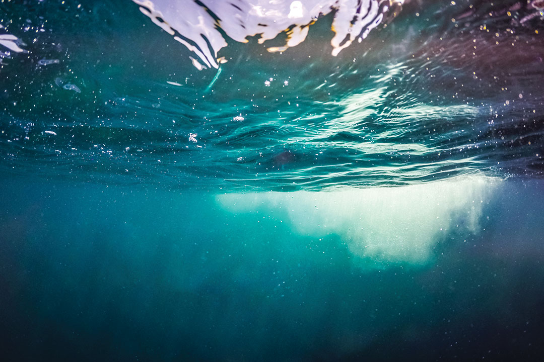 Vintage underwater bokeh background. Deep blue sea background design, website template and horizontal banner.