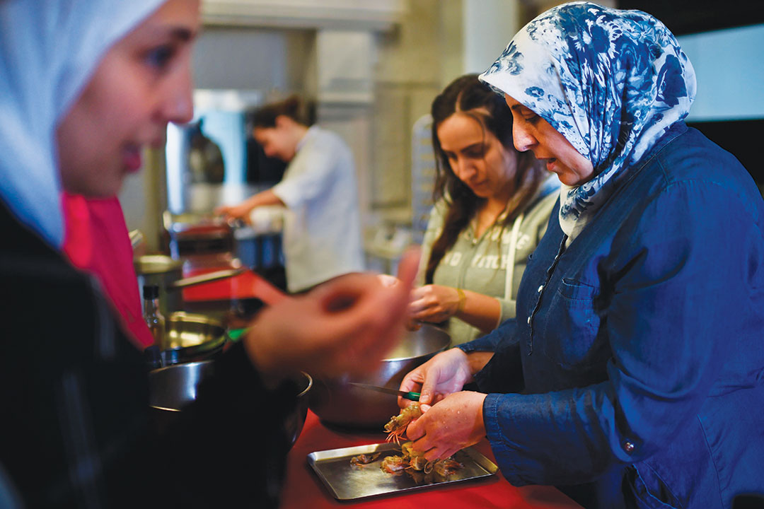 Syrian refugee Fatima (R) attends cooking lessons at Lisbon's Hotel and Tourism school on May 29, 2017.