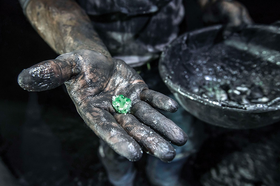 A miner shows a rough emerald extracted from Puerto Arturo pit, one of the pits of Muzo emerald mine owned and operated by American company Mineria Texas Colombia