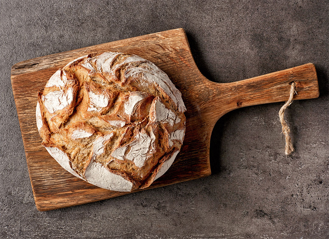 Freshly baked bread on dark gray kitchen table, top view