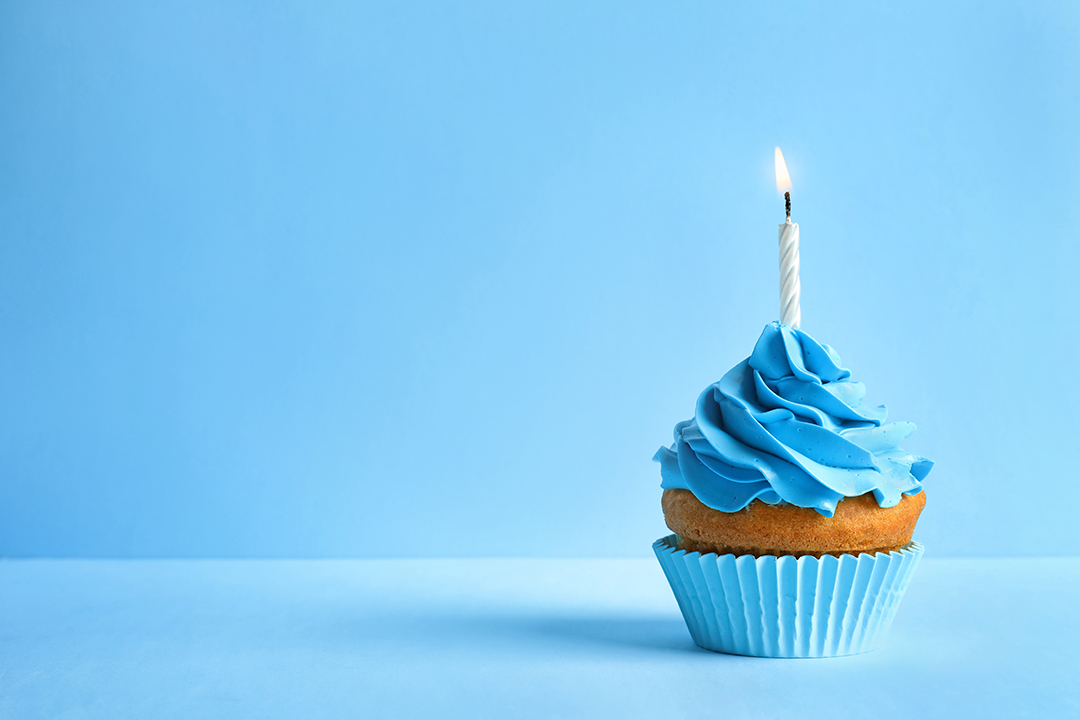 Birthday cupcake with a blue background