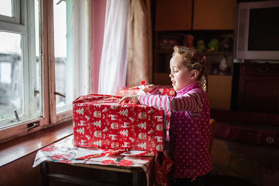 girl open a big red present