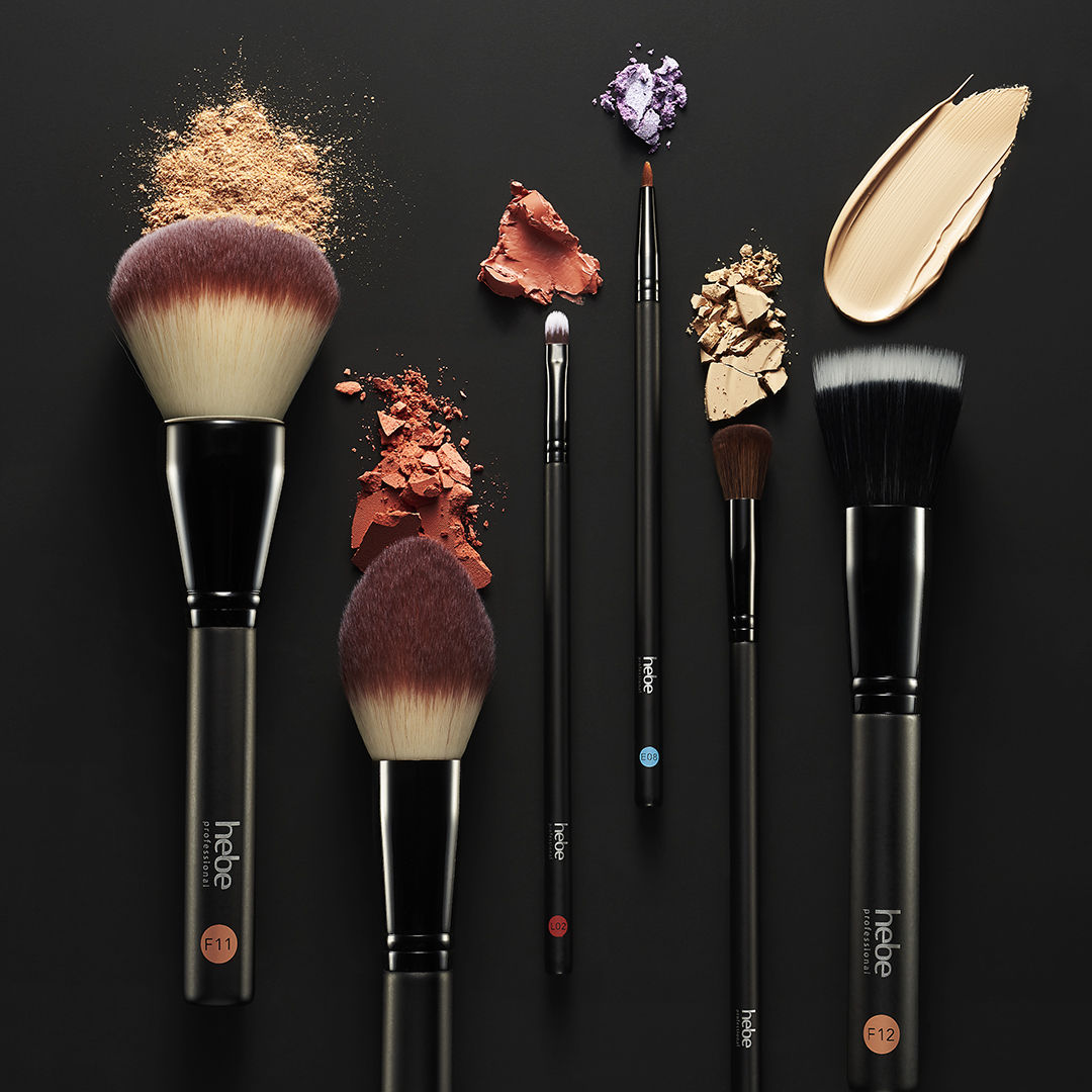 makeup and brushes on black background