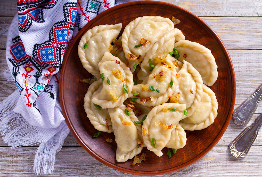 Dumplings, filled with cabbage. Varenyky, vareniki, pierogi, pyrohy - dumplings with filling. View from above, top studio shot