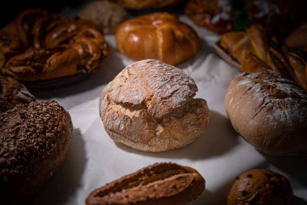 cakes and breads displayed on a table