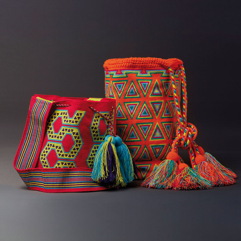 two colorful wayuu bags, one with red and green colors and motifs, other with orange and blue colors and motifs