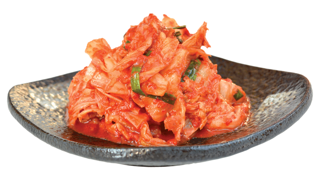 Kimchi on black plate, isolated on white background