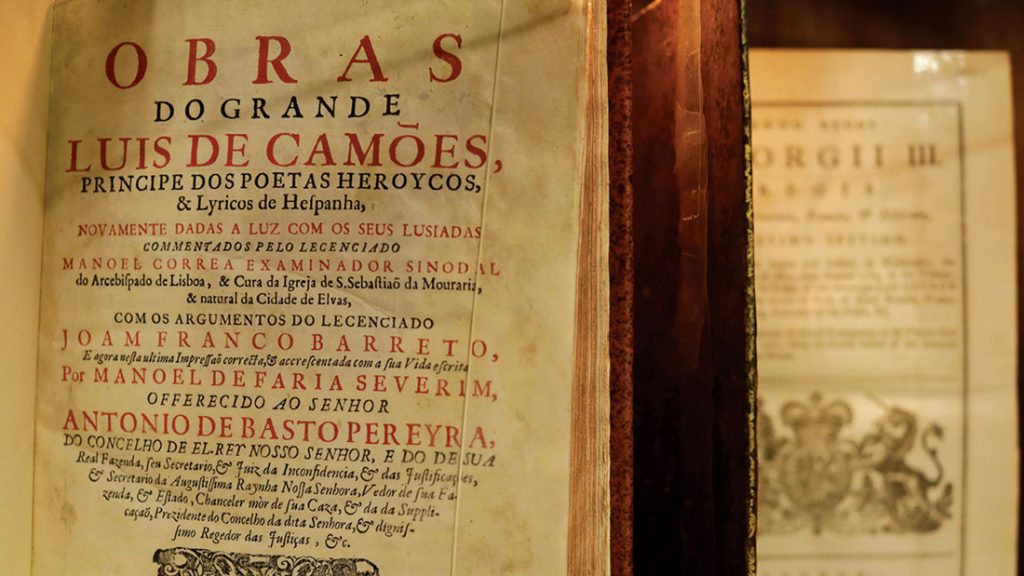 An open book showing Luis de Camões' poem