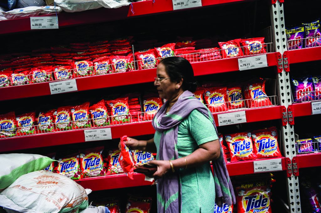 A shopper takes a bag of Procter & Gamble Co. Tide detergent off the shelves of a Bharti Walmart Pvt. Ltd.