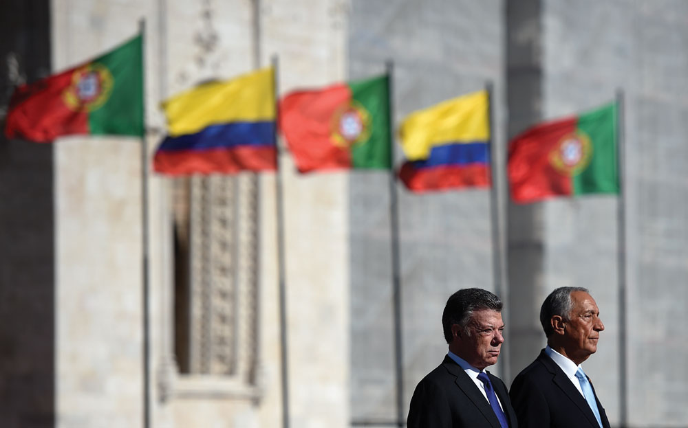 Colombian president Jose Manuel Santos (L) and his Portuguese counterpart Marcelo Rebelo de Sousa listen to national anthems during a welcoming ceremony at Praca do Imperio square in Lisbon on November 13, 2017.
