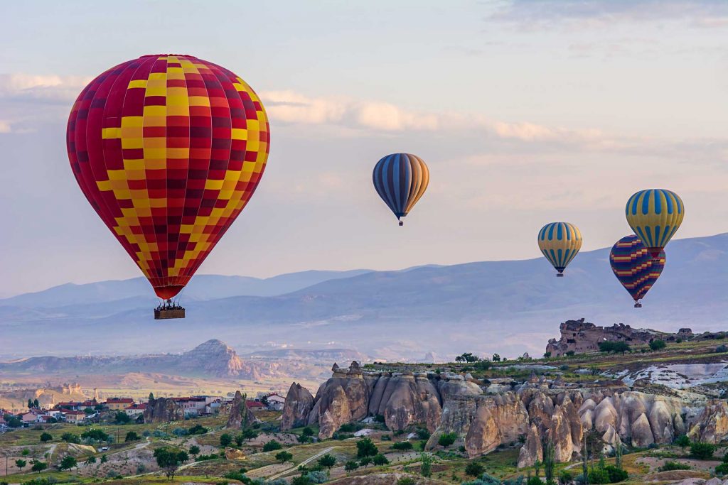 Colorful hot-air balloons flying over the mountain