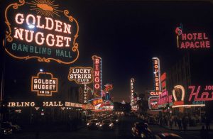 View of the illuminated sign of casinos and hotels along Fremont Street, Las Vegas, Nevada, 1955. Visible are signs for the Golden Nugget, the Lucky Strike Club, the Pioneer Club, the Las Vegas Club, the Boulder Club, and the Hotel Apache, among others.