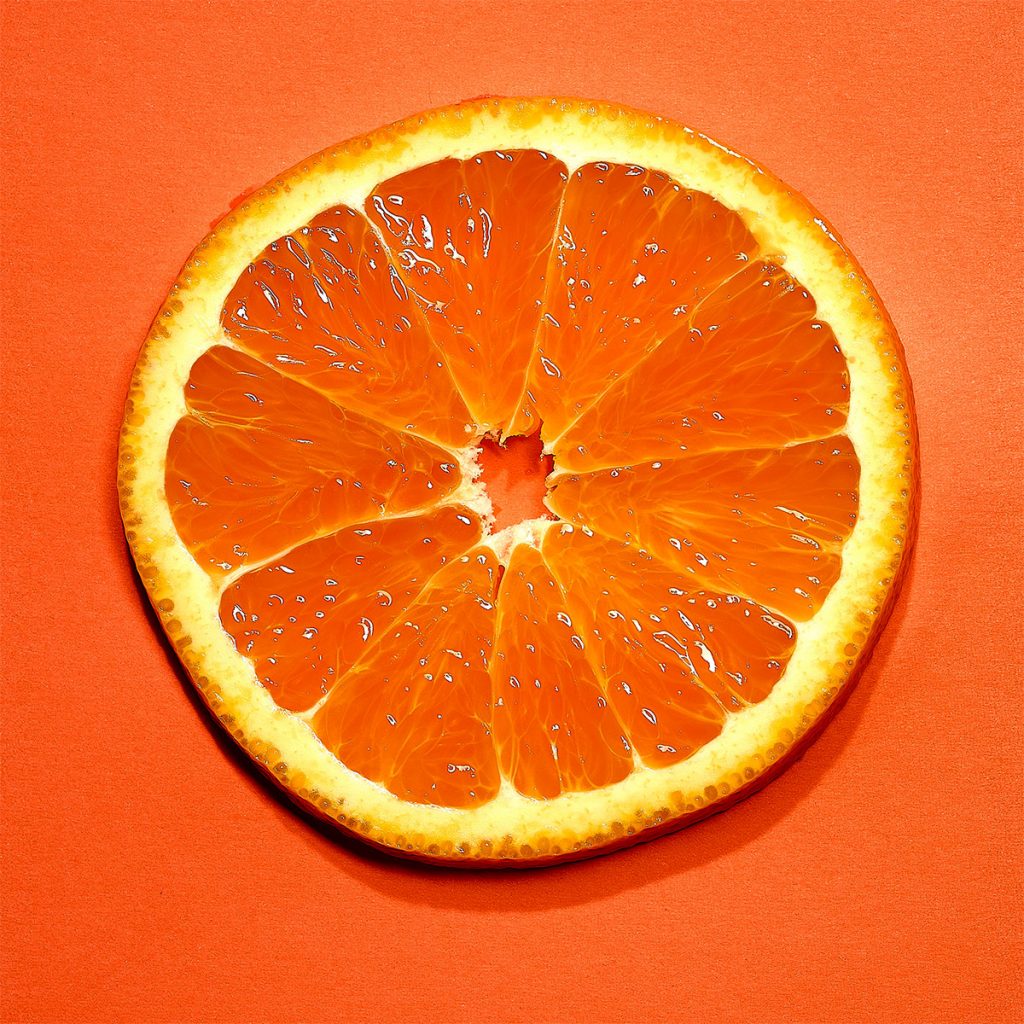 Photography slice of an orange on orange background