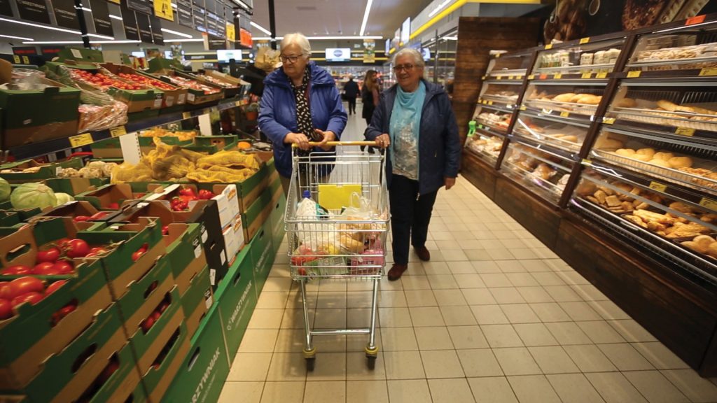 old people shopping in supermarket