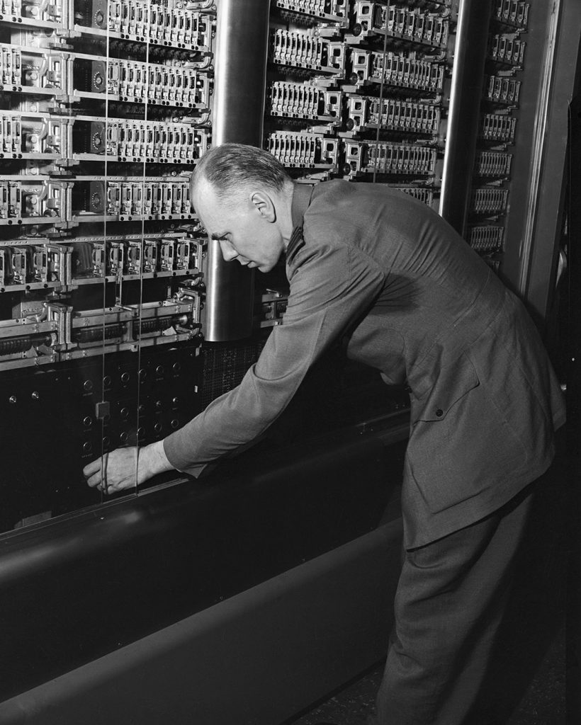 This machine, the world's greatest calculating machine will be presented to Harvard University today. Commander Howard H. Aiken, USNA, the inventor of the calculator, in the Research Laboratory of Physics at Harvard, is here tweaking the calculator.