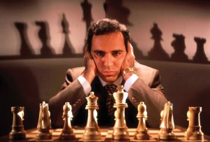 Chess champion Gary Kasparov contemplating board, training for his May rematch w. smarter version of Deep Blue, IBM computer that spooked him last yr.