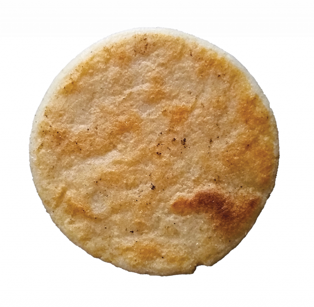 closeup of an arepa in the pan