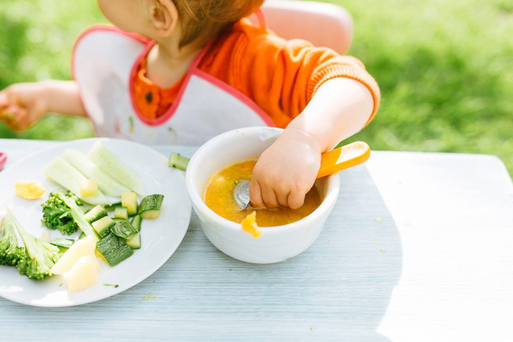 baby eating lunch on outdoor garden