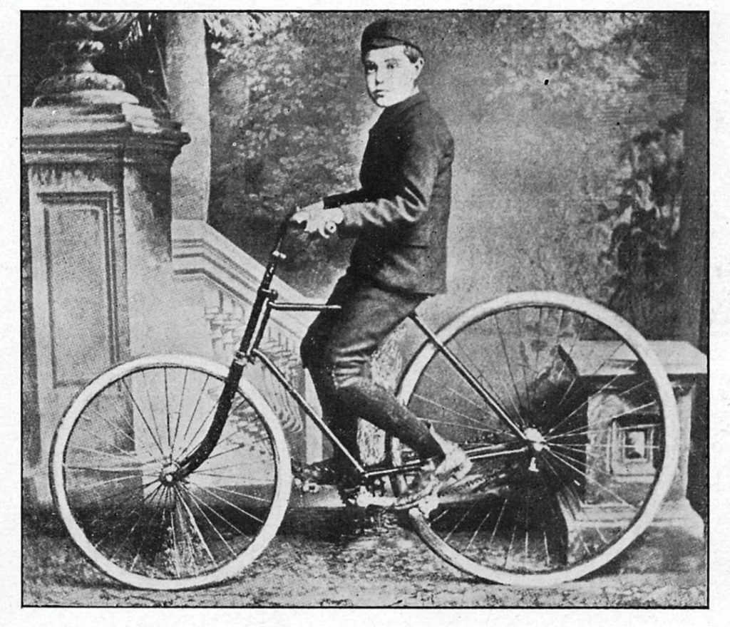 The son of J.B. Dunlop riding the first bicycle with inflatable tyres.