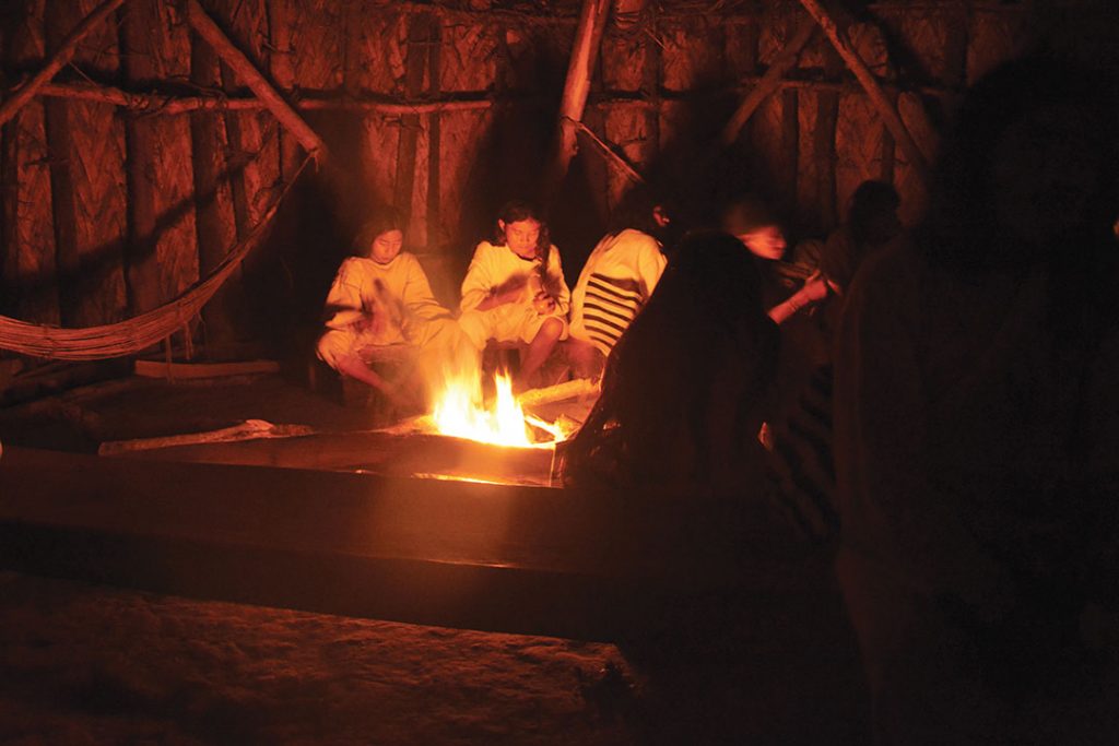 Indigenous kogui inside a “Kansamaria”, the tribe’s ceremonial temple. This great structure has a circular floor plant resembling beehives, or straight-walled structures with conical roofs.