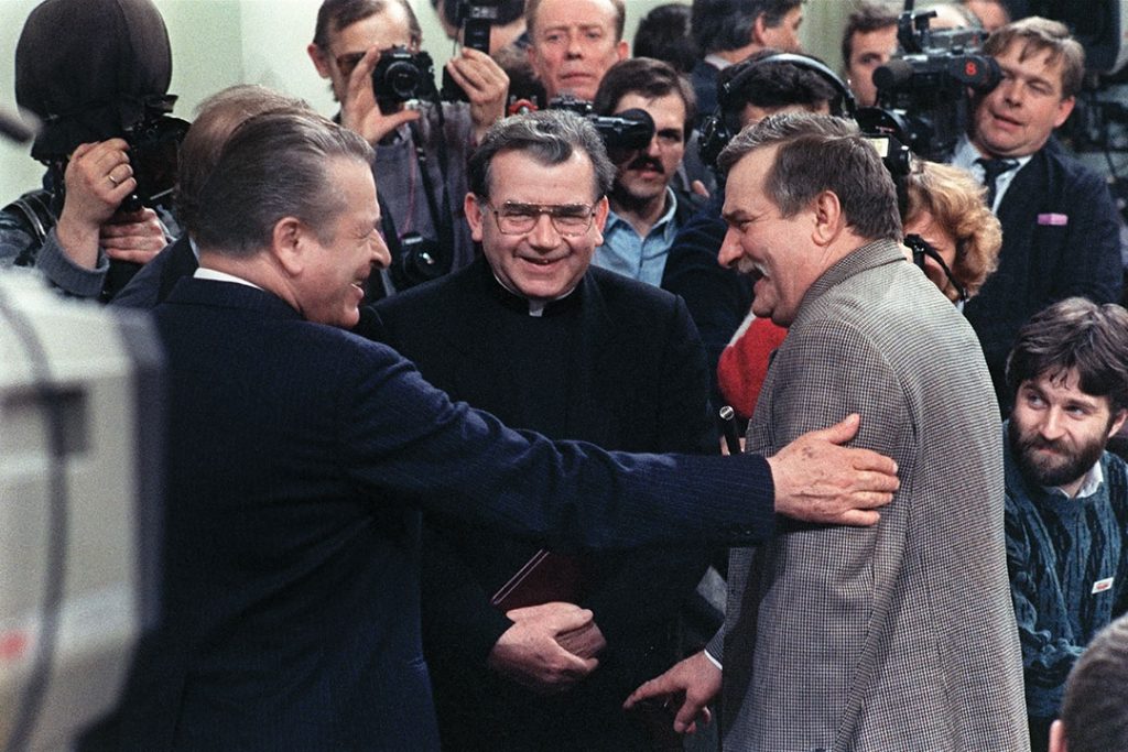 Lech Walesa (R) leader of Solidarnosc, jokes with Czeslaw Kiszczak (L) as Father Alojzy Orszulik (C) looks on before attends the final session of the round table talks in Warsaw, Poland on April 05, 1989 between the Polish governement and the opposition.