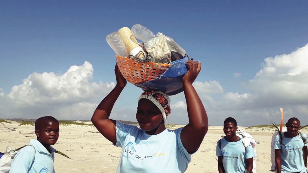 Women cleaning the plastic of the beach