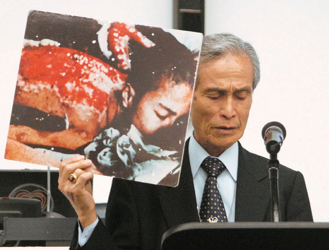 File photo taken in May 2010 shows A-bomb survivor Sumiteru Taniguchi giving a speech at the U.N. conference on reviewing the Nuclear Non-Proliferation Treaty in New York with a picture of himself suffering from severe burns caused by the U.S. atomic bombing of Nagasaki in 1945. Taniguchi died of duodenal papilla cancer on Aug. 30, 2017, at age 88. (Kyodo) ==Kyodo (Photo by Kyodo News Stills via Getty Images)