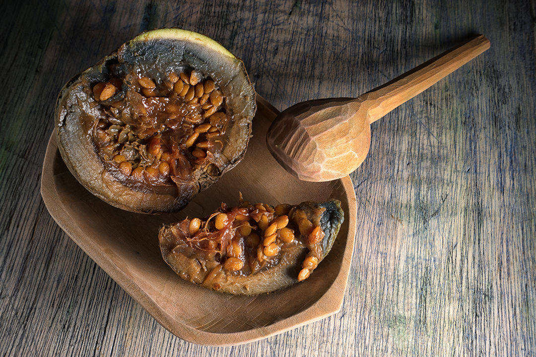 borojo fully ripe fruit closeup in wood bowl on wood surface