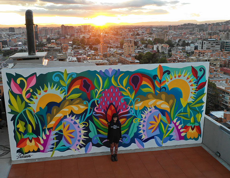 Street Artist Ledania with one of her murals