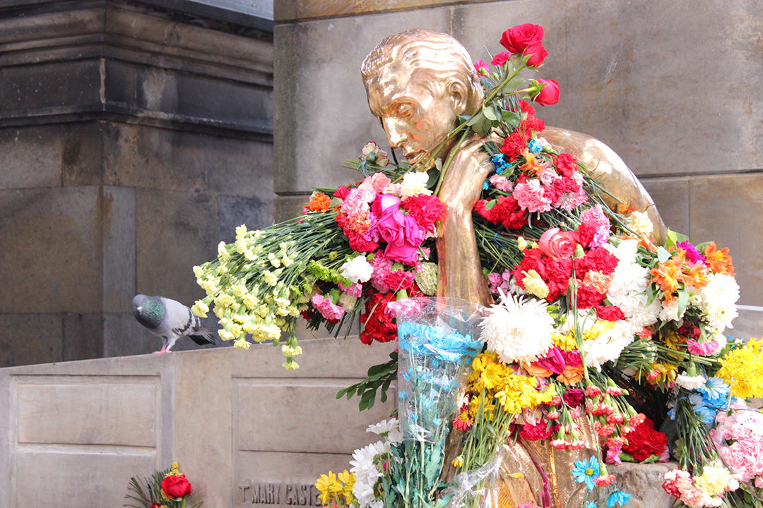 Leo Kopp's statue full of colorful flowers