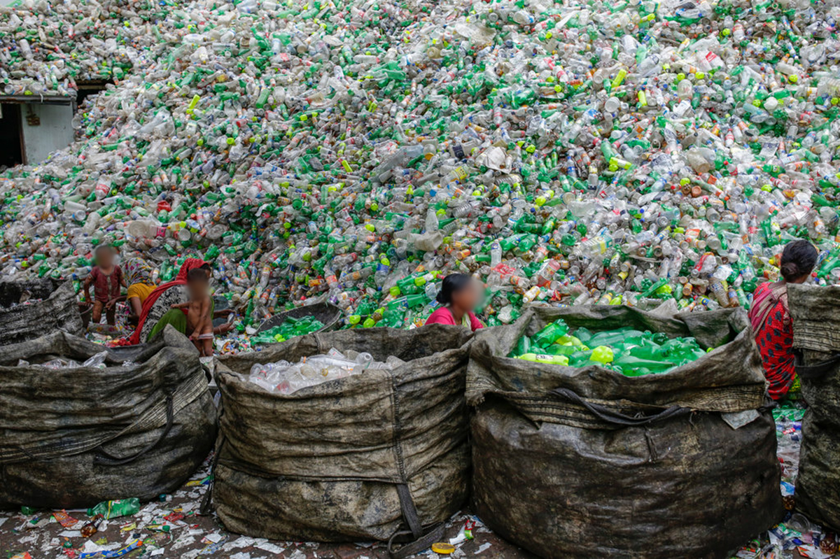 Figure 6.6 Female workers sort out plastic bottles for recycling in a factory in Dhaka, Bangladesh.