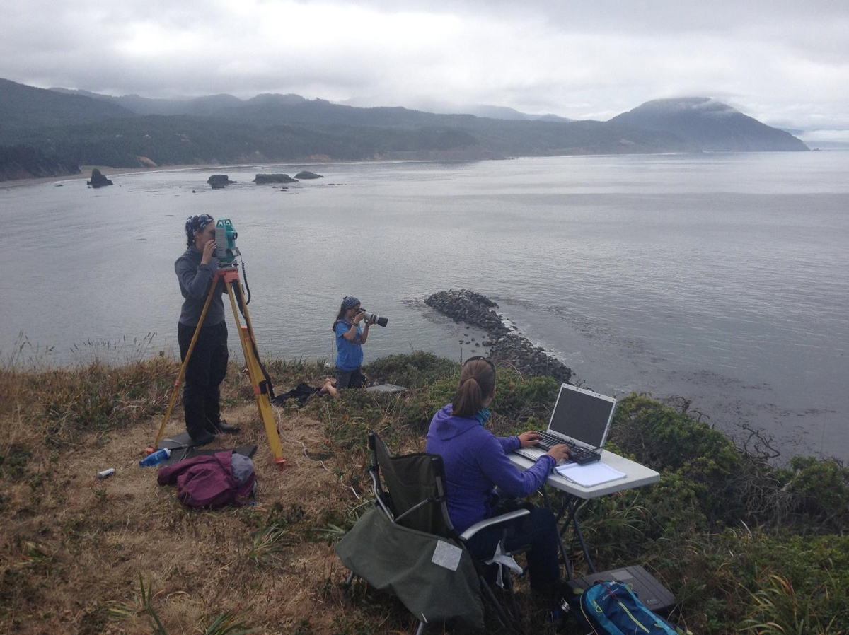 Team tracks and photographs a gray whale from a cliff