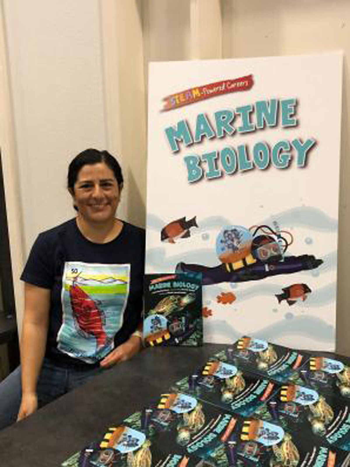 Maria with English and Spanish versions at a JEP book Assembly, photo by: Linda Chilton, permission to be reproduced