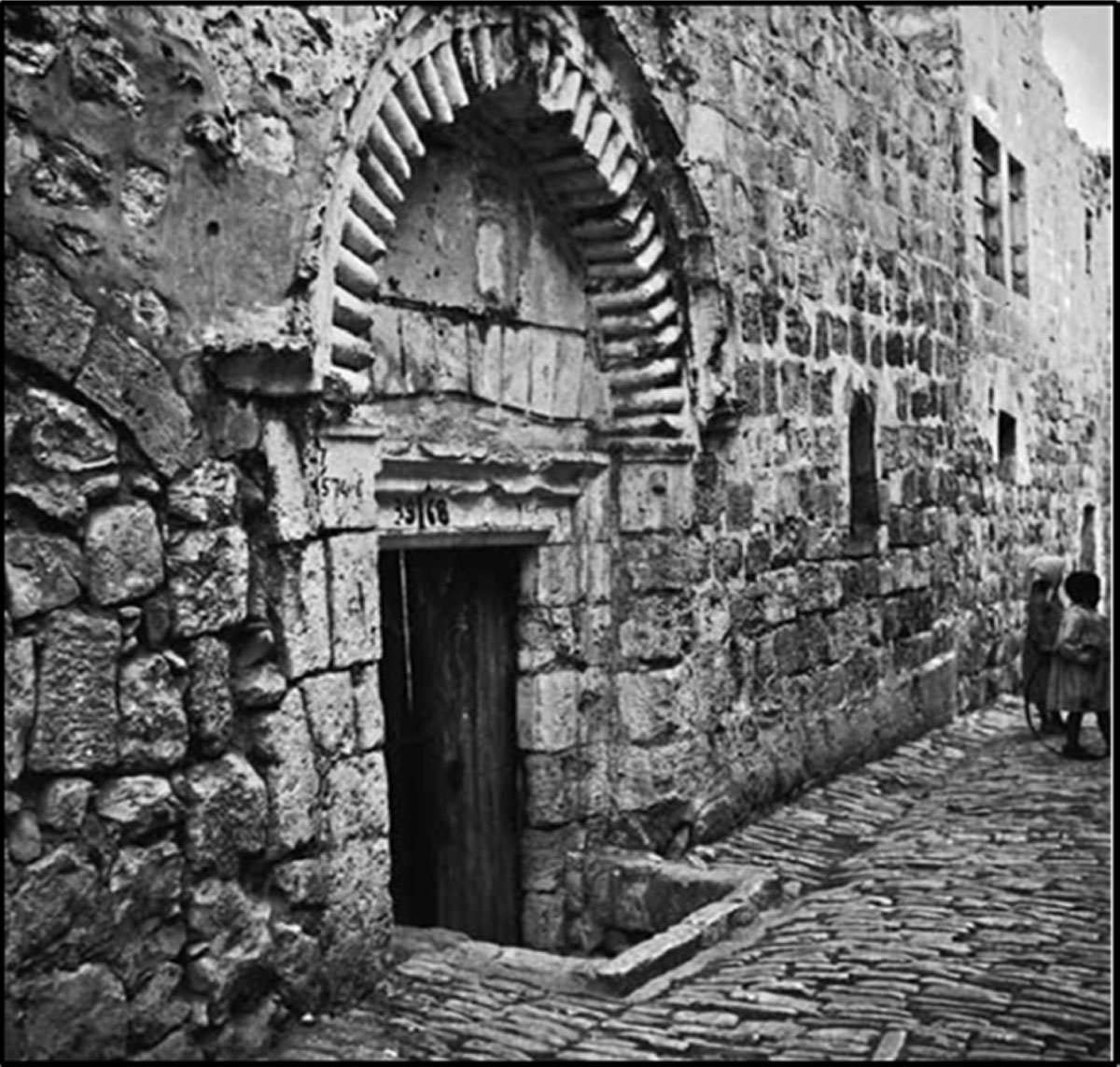 Old photograph of the door with arch of the madrassa al-Afdaliyya