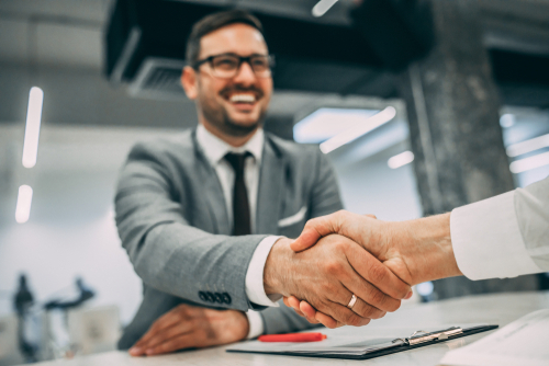 A businessman shaking a hand.