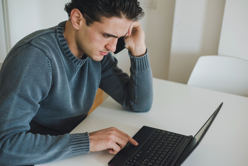 Man searching online on his computer.