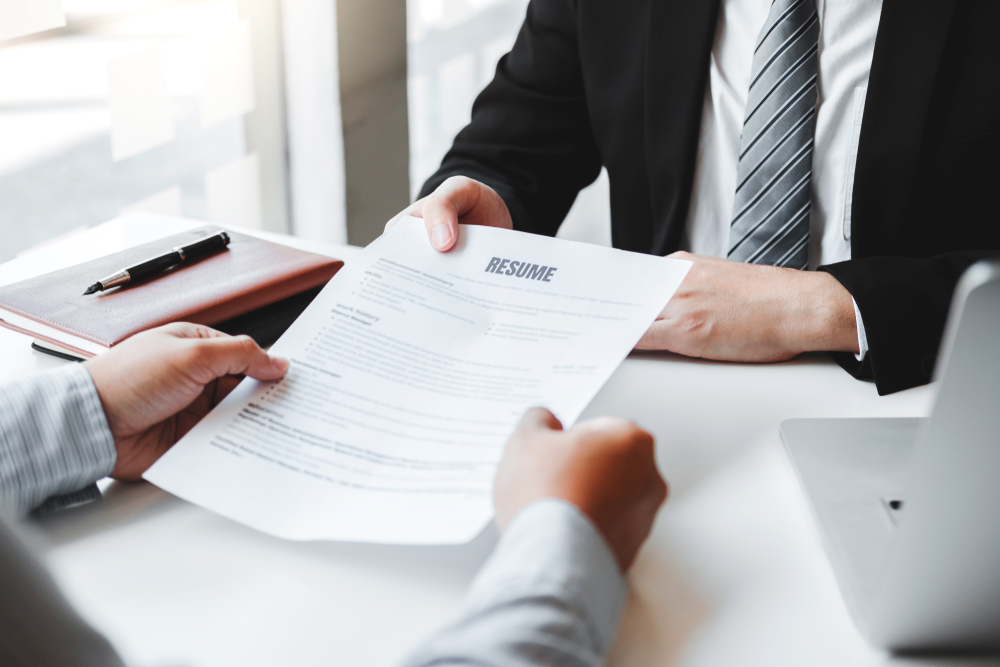 A man presents a resume during a job interview.